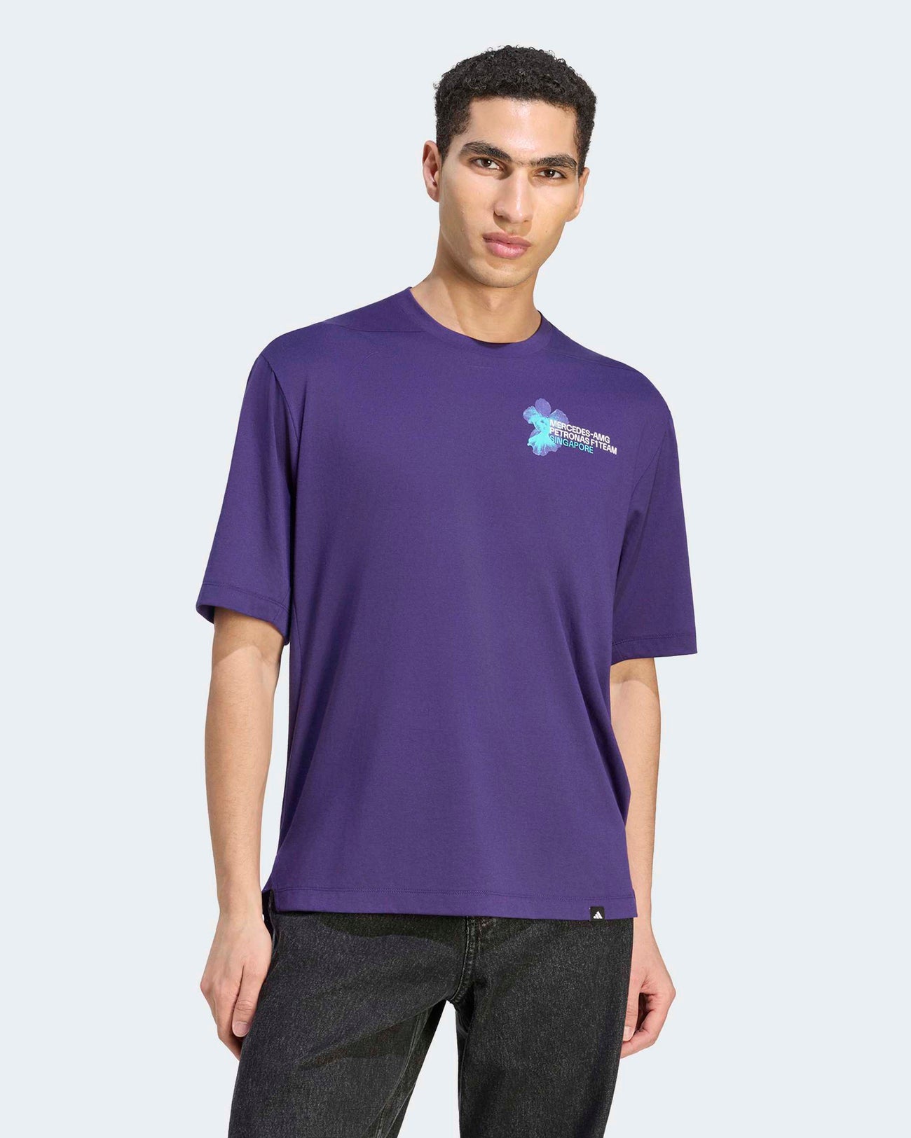Male model wearing the purple Mercedes-AMG Petronas F1 Team Vanda Bloom T-shirt featuring a subtle chest graphic.