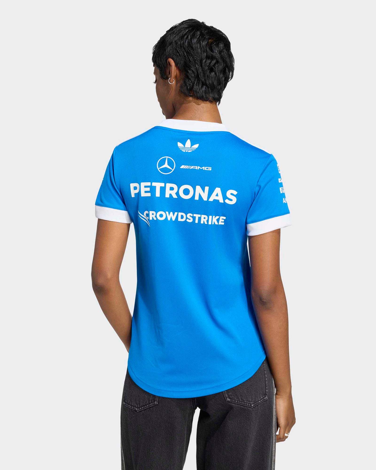 Rear view of the blue Women's 2026 Blue Wonder F1 Team tee with white sponsor and team logos.